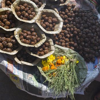 Bowls with saffron water and flowers at Bodhnath stupa in Kathmandu valley, Nepal

