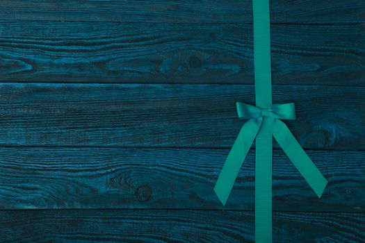 Grunge plank wood texture background with green ribbon