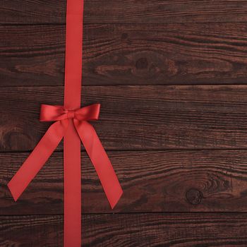red ribbon on Grunge plank wood texture background