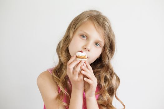 Beautiful little girl holding a delicious appetizing cake