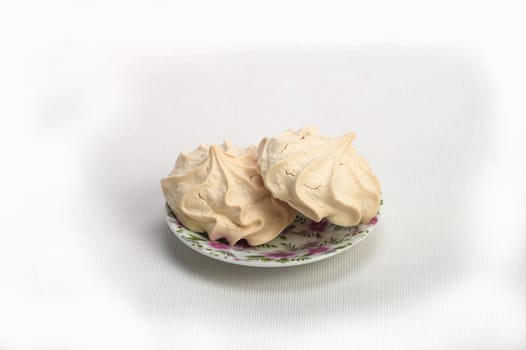 Fresh delicious meringue cookies served with tea or coffee macro