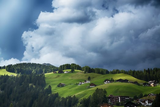 Thunderstorm formation over the green hills and forest of the Dolomites, Trentino-Alto Adige - Italy