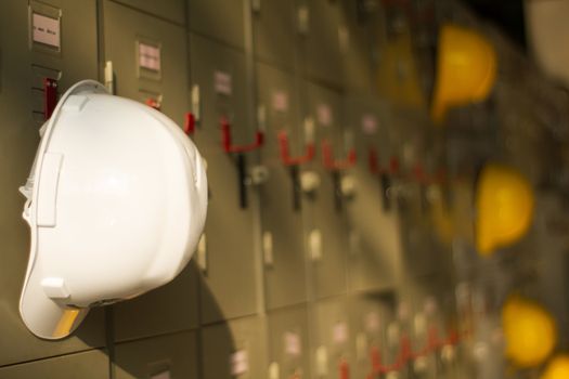 Safety helmet hanging on locker for worker equipment