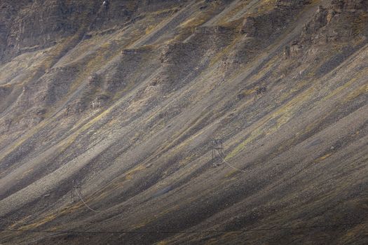 Beautiful scenic view of blue gulf under barren mountain range with melting snow against the background of dramatic evening sky near Barentsburg, Spitsbergen (Svalbard island), Norway, Greenland sea

