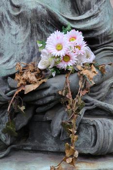 Withered flowers on the statue.