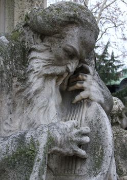 Old bearded musician statue.