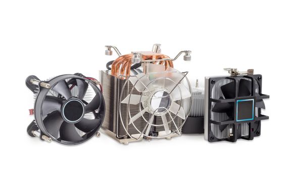 One active CPU cooler with a large finned heatsink, fan, copper thermal pad with heat pipes and several various CPU coolers with aluminum finned heatsinks and fans on a light background
