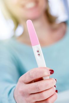 pregnancy test positive result smiling woman