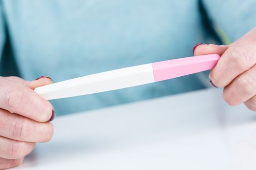 Young woman holding a Pregnancy Test in her hands