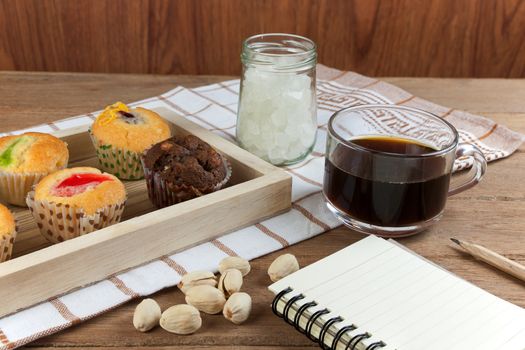 Cupcake various flavors in wood tray on wood table. coffee break with the idea