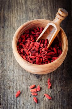 Dried goji berries placed on wooden surface