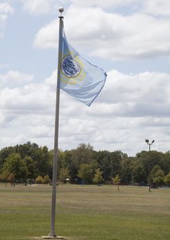 South Dakota state flag waving in blue sky