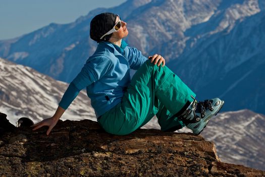 Young woman on the top of the mountain