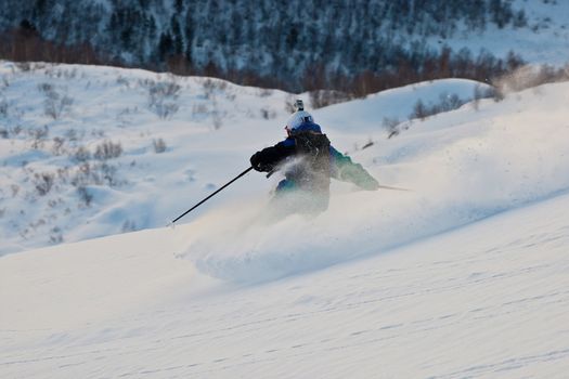 The silhouette of freerider in the snow powder
