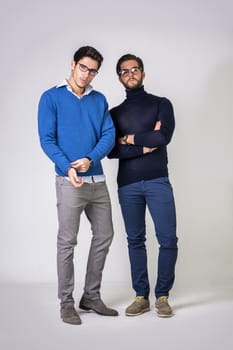 Two good-looking men in stylish clothes.Studio shot.