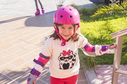 Little girl smiling having fun skating