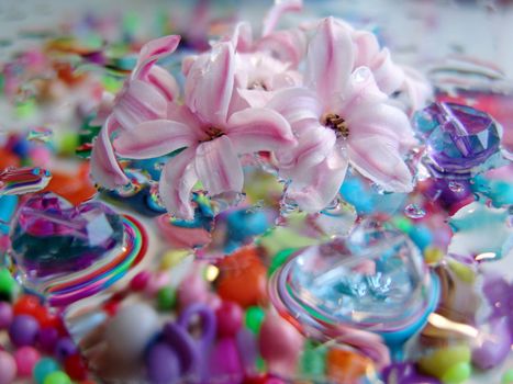 water drops on multicolor background.of glass hearts. flowers