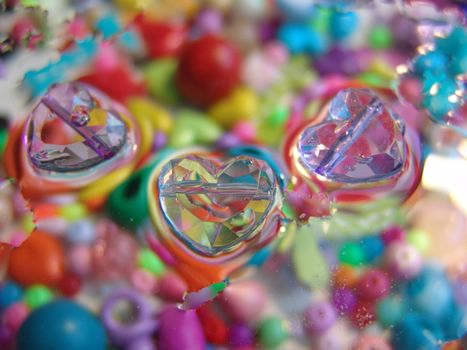 water drops on multicolor background.of glass hearts