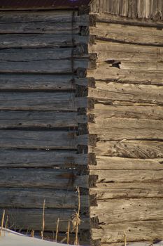 Closeup of log cabin barn walls and conrer in sunshine