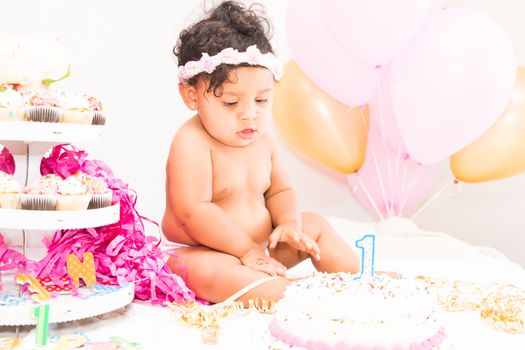 Young Baby Girl Celebrating Her First Birthday With Cake