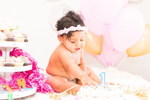 Young Baby Girl Celebrating Her First Birthday With Cake
