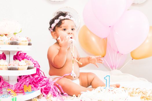 Young Baby Girl Celebrating Her First Birthday With Cake