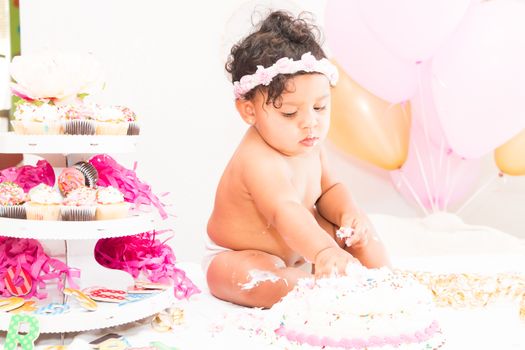 Young Baby Girl Celebrating Her First Birthday With Cake