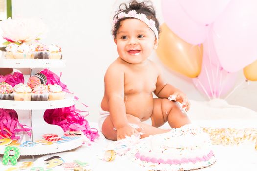 Young Baby Girl Celebrating Her First Birthday With Cake