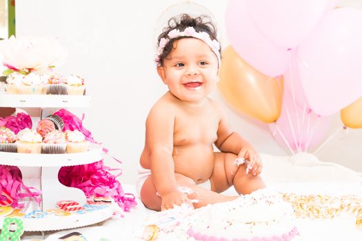 Young Baby Girl Celebrating Her First Birthday With Cake