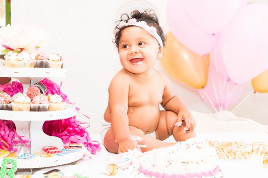 Young Baby Girl Celebrating Her First Birthday With Cake
