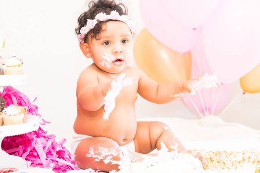 Young Baby Girl Celebrating Her First Birthday With Cake