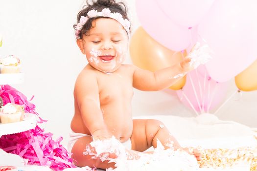 Young Baby Girl Celebrating Her First Birthday With Cake