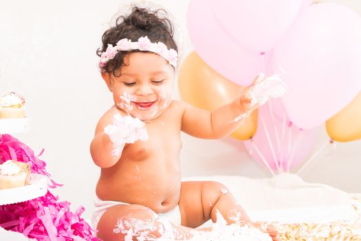 Young Baby Girl Celebrating Her First Birthday With Cake