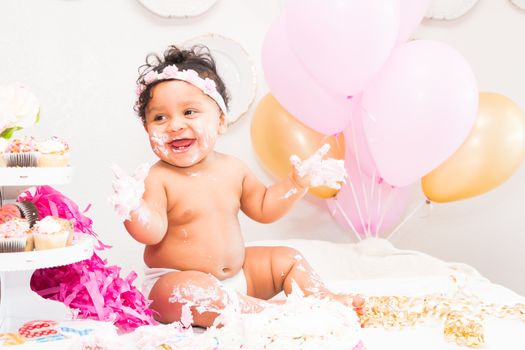 Young Baby Girl Celebrating Her First Birthday With Cake