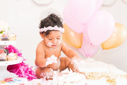 Young Baby Girl Celebrating Her First Birthday With Cake