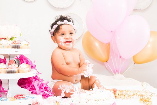 Young Baby Girl Celebrating Her First Birthday With Cake