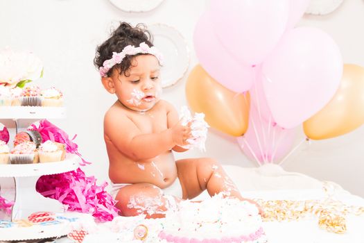 Young Baby Girl Celebrating Her First Birthday With Cake