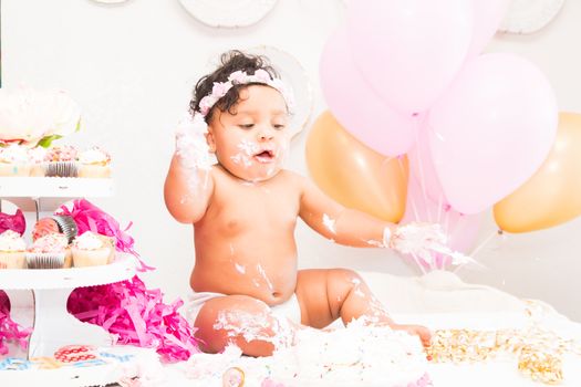 Young Baby Girl Celebrating Her First Birthday With Cake