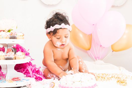 Young Baby Girl Celebrating Her First Birthday With Cake