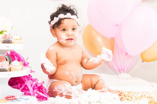 Young Baby Girl Celebrating Her First Birthday With Cake