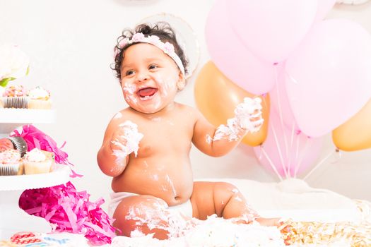 Young Baby Girl Celebrating Her First Birthday With Cake