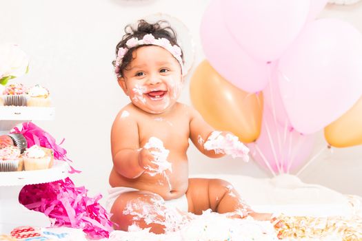 Young Baby Girl Celebrating Her First Birthday With Cake