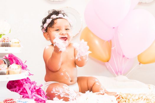 Young Baby Girl Celebrating Her First Birthday With Cake