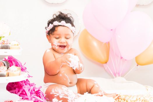 Young Baby Girl Celebrating Her First Birthday With Cake