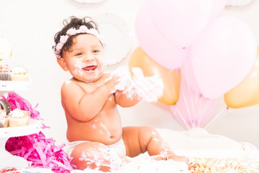 Young Baby Girl Celebrating Her First Birthday With Cake