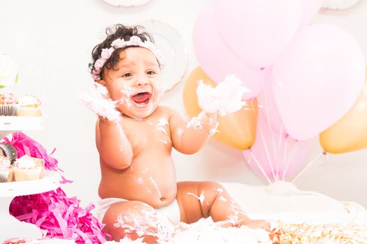 Young Baby Girl Celebrating Her First Birthday With Cake