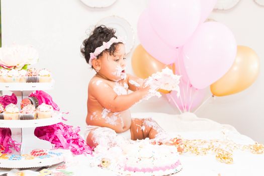 Young Baby Girl Celebrating Her First Birthday With Cake