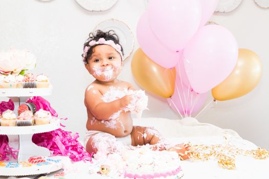 Young Baby Girl Celebrating Her First Birthday With Cake