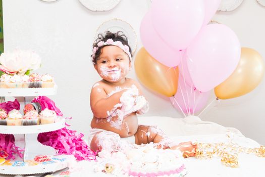 Young Baby Girl Celebrating Her First Birthday With Cake