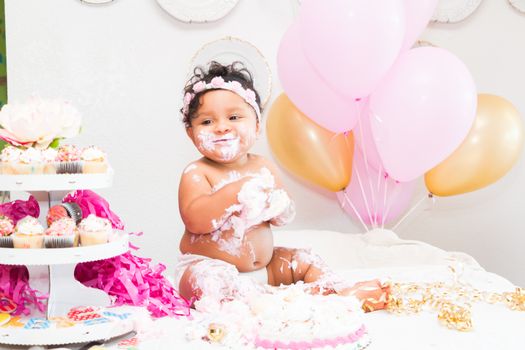 Young Baby Girl Celebrating Her First Birthday With Cake